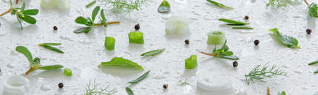 Composition of fresh green vegetables and herbs on white background. Vegetable salad ingredients. Creative food pattern. Flat layの写真素材
