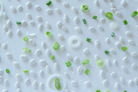 Food pattern with beans, onion, tomatoes, salt and pepper on white backgroundの写真素材