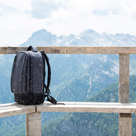 Close up of touristic backpack, sport adventure equipment, mountain background