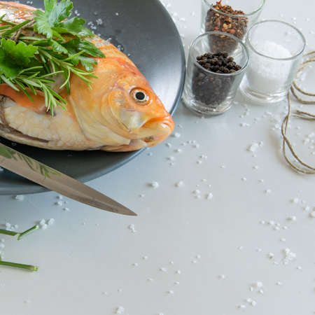 Cooking red  Carassius fish with fresh herbs. Healthy eating concept, space for text or menuの写真素材