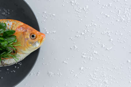 Cooking red  Carassius fish with fresh herbs. Healthy eating concept, space for text or menuの写真素材