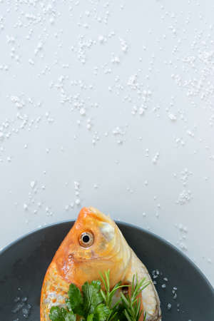 Cooking red  Carassius fish with fresh herbs. Healthy eating concept, space for text or menuの写真素材