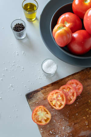Cooking tomatoes, preparing fresh salad. Vegetarian dietの写真素材