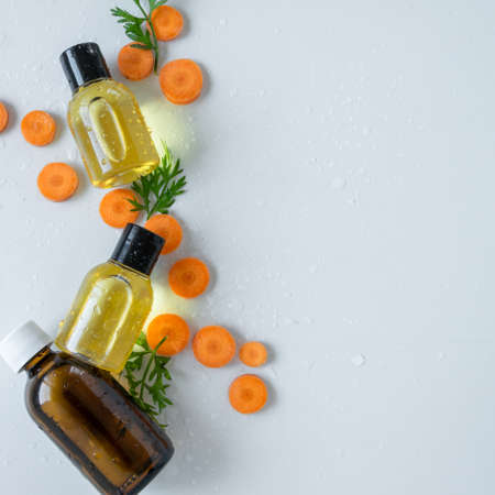 Top view of bottles with carrot essential oil. Healthy cosmetic productの写真素材