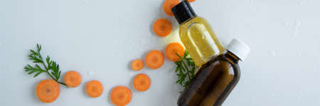Top view of bottles with carrot essential oil. Healthy cosmetic productの写真素材