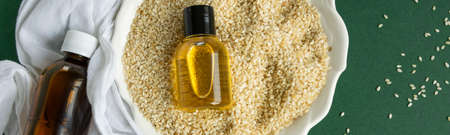 Top view of bottles with sesame seed essential oil. Massage cosmetic treatmentの写真素材