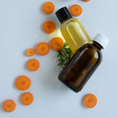 Top view of bottles with carrot essential oil. Healthy cosmetic productの写真素材