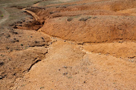 Albanian nature landscape. Sandy hills with rainwater sign on the groundの写真素材