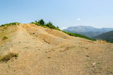 Albanian nature landscape. Sandy hills with rainwater sign on the groundの写真素材