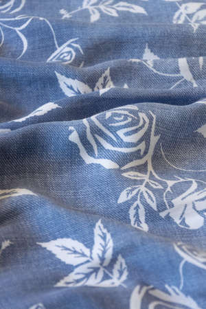 Close up crop view of blue cloth with flower details