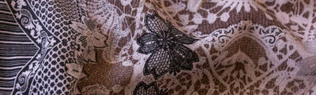 Close up crop view of warm pastel colors cloth with flower details