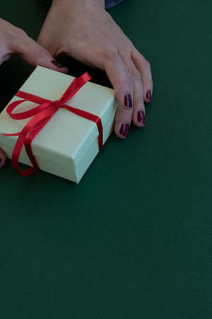 Close up view of woman hands holding a gift box, space for text