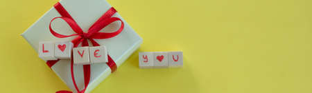 Isolated gift box with "Love you" on text yellow background and copy spaceの写真素材