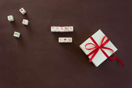 Isolated gift box with Thank you  text on brown background