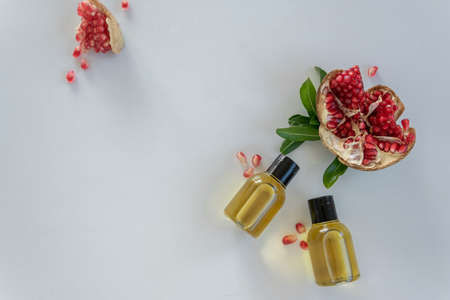 Top view of bottles with pomegranate seed essential oil. Massage cosmetic treatment