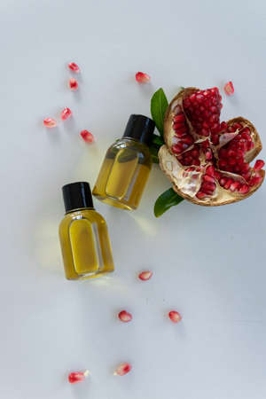 Top view of bottles with pomegranate seed essential oil. Massage cosmetic treatmentの写真素材