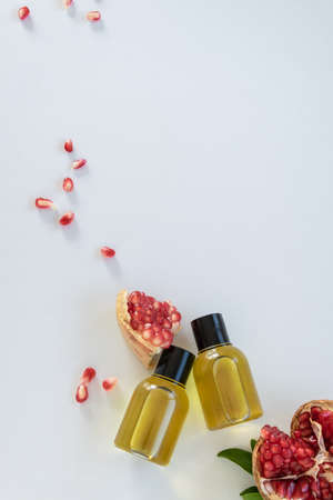 Top view of bottles with pomegranate seed essential oil. Massage cosmetic treatmentの写真素材