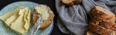 Whole oat sliced bread and fresh butter. Healthy eating concept