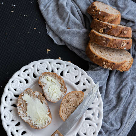 Whole oat sliced bread and fresh butter. Healthy eating concept