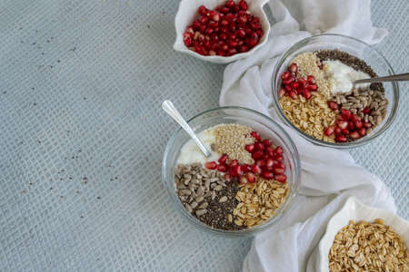 Healthy breakfast mood, muesli with raw pomegranate, sunflower and sesame seeds.の写真素材