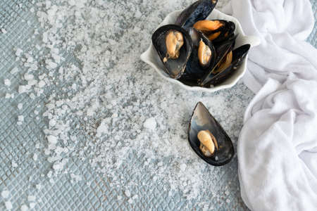 Cooked delicious black mussel, salty white background. Healthy eating concept, rich protein  food