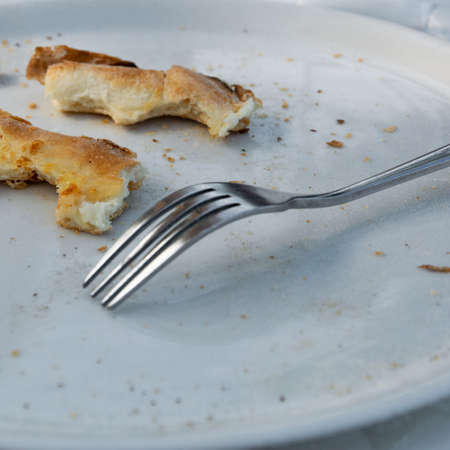 Empty dirty plate after eating pizzaの写真素材