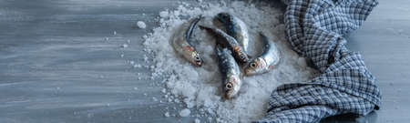 Top view of woman hands preparing fresh anchovies. Healthy raw seafood