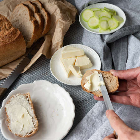 Top view of woman hands preparing healthy homemade sandwiches with vegetables and hard-boiled eggsの写真素材