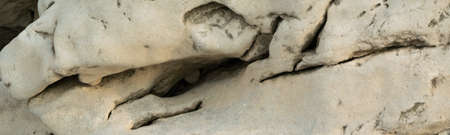 Detail of natural rough stone, rippled rock backgroundの写真素材