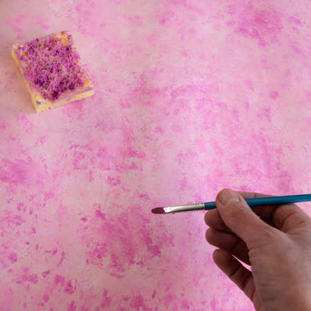 Top view of woman hand painting pink background, artistic creative occupationの写真素材