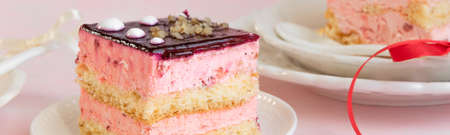 Yummy slices of strawberry cake on pink background, creamy dessert, holiday themesの写真素材