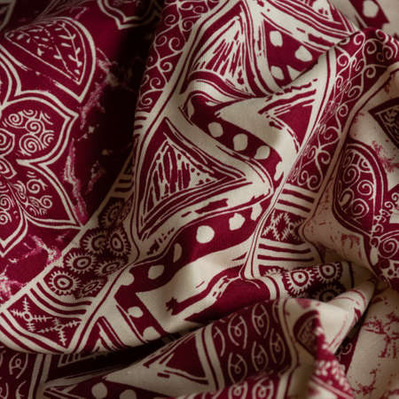 Folded oriental cloth. Crop view of fashioned ethnic fabric
