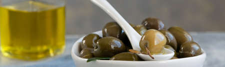 Green olives and olive oil, healthy eating, cooking ingredientsの写真素材