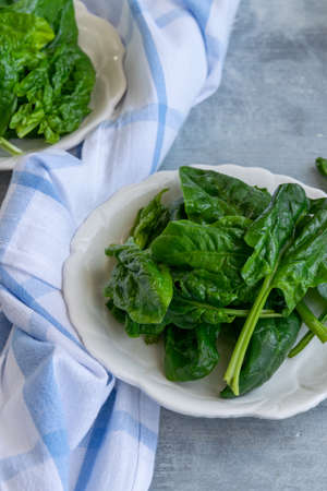 Close up view of raw spinach salad, vegetarian healthy ingredientの写真素材