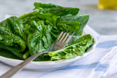 Close up view of raw spinach salad, vegetarian healthy ingredientの写真素材