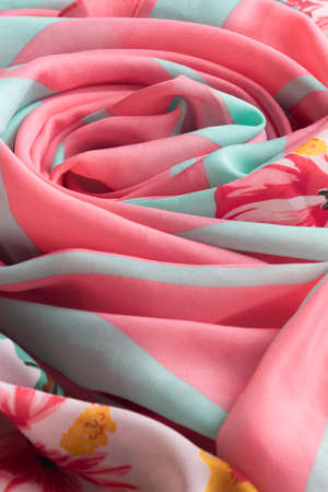 Fresh colorful folded cloth. Crop view of fashioned botanical fabric, pink and blue pastel colors