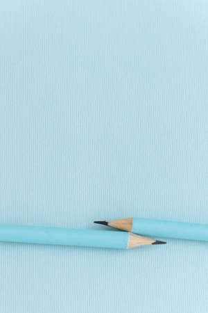 Pastel colored pencils on empty sheet, blue tonedの写真素材