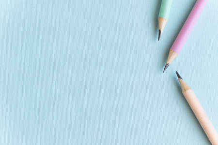 Pastel colored pencils on empty sheet, blue tonedの写真素材