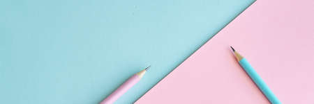 Pastel colored pencils on empty sheet, blue and pink tonesの写真素材