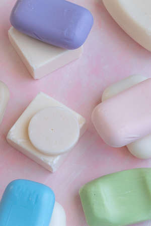 Different handmade  bar soaps on pink background. Hygiene, artisanal productsの写真素材