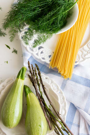 Cooking spaghetti with vegetables - wild asparagus, dill and zucchiniの写真素材
