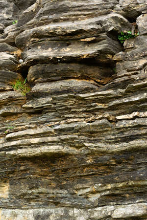 Detail of natural rough stone, rippled rock backgroundの写真素材