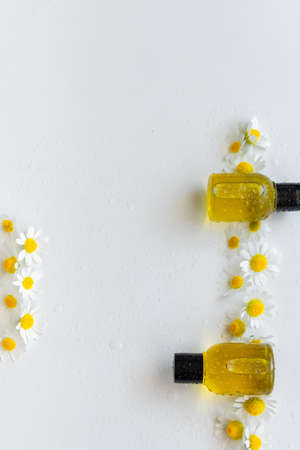 Essential oil with chamomile flower extract. Hygiene bath product. Wellness therapy regenerationの写真素材