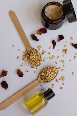 Top view of natural cosmetic products with oats, dry flowers and herbs. Wellness beauty treatment....