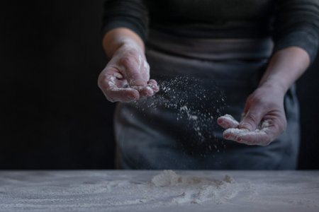 Woman baker with flour in her hands