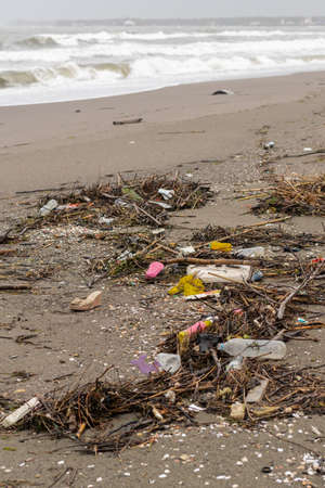 Trash thrown away in the beach, environmental problems. Natural disaster conceptの写真素材