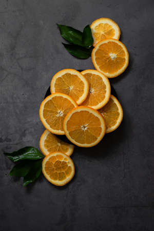 Sliced oranges on vintage golden plateの写真素材