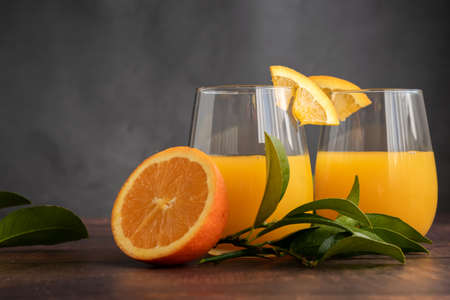 Freshly squeezed orange juice on wooden backgroundの写真素材