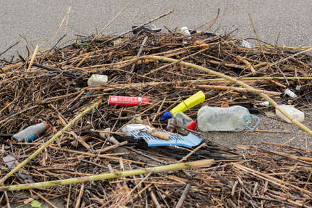 Trash thrown away in the beach, environmental problems. Natural disaster conceptの写真素材