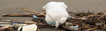 Trash thrown away in the beach, environmental problems. Natural disaster conceptの写真素材